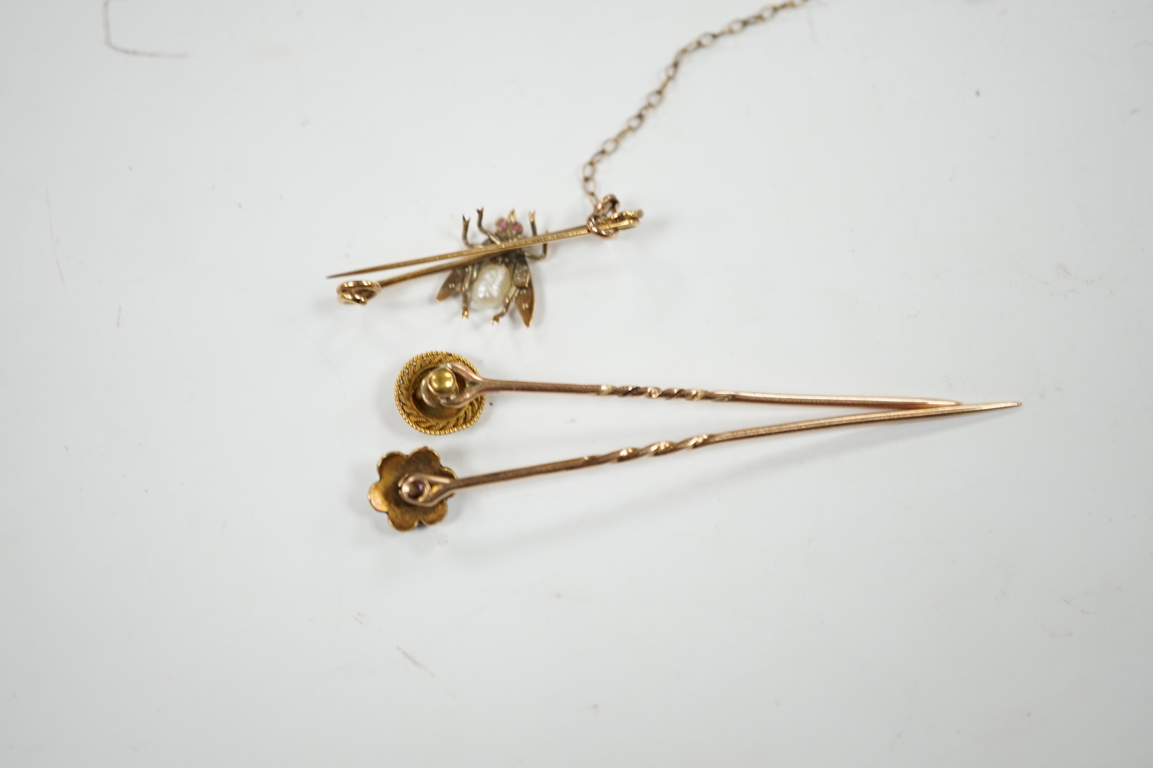 An early 20th century 9ct and gem set bug brooch, 34mm and two yellow metal stick pins, diamond and diamond and seed pearl set.